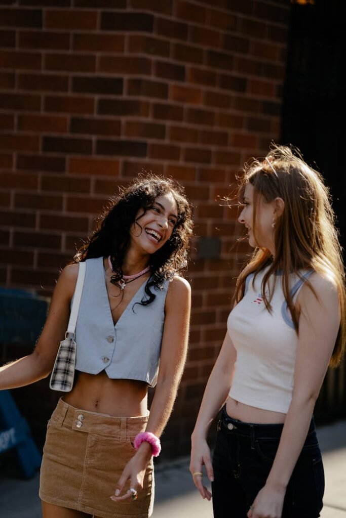 Two Teenage Girls in Trendy Clothing Walking in City