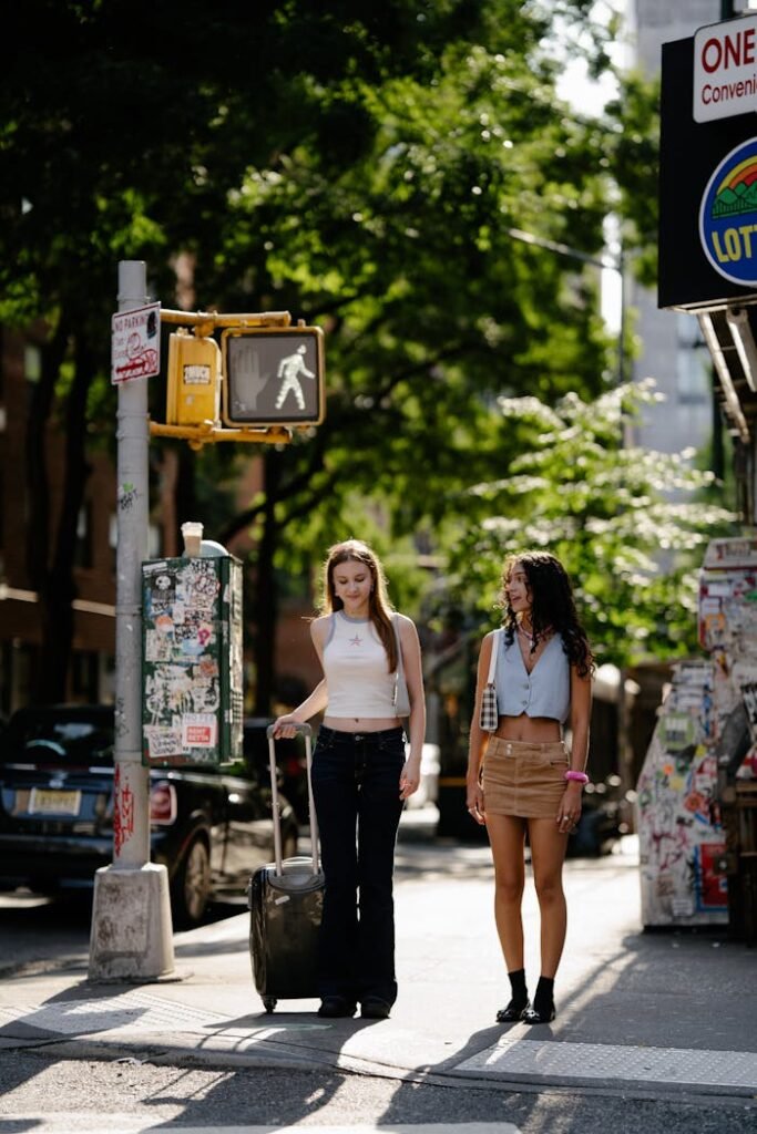 Young Girls Walking in City with a Suitcase